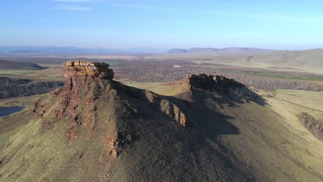 aerial view of a mountain range with a blue sky