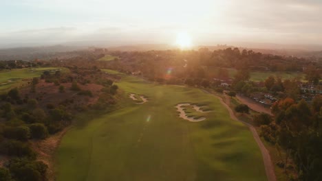 aerial view of a golf course at sunset