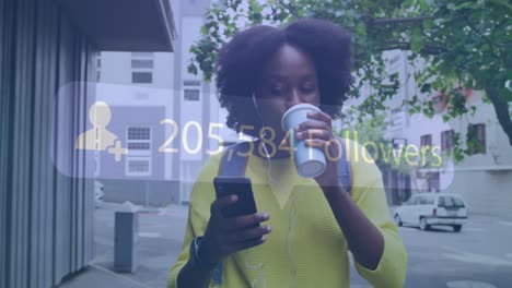 Animation-of-social-media-notification-over-african-american-woman-using-smartphone-in-city-street