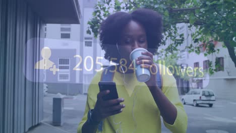 animation of social media notification over african american woman using smartphone in city street