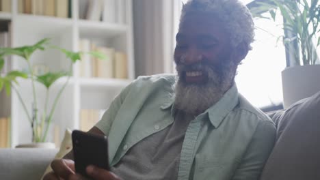 Video-of-african-american-senior-man-using-smartphone