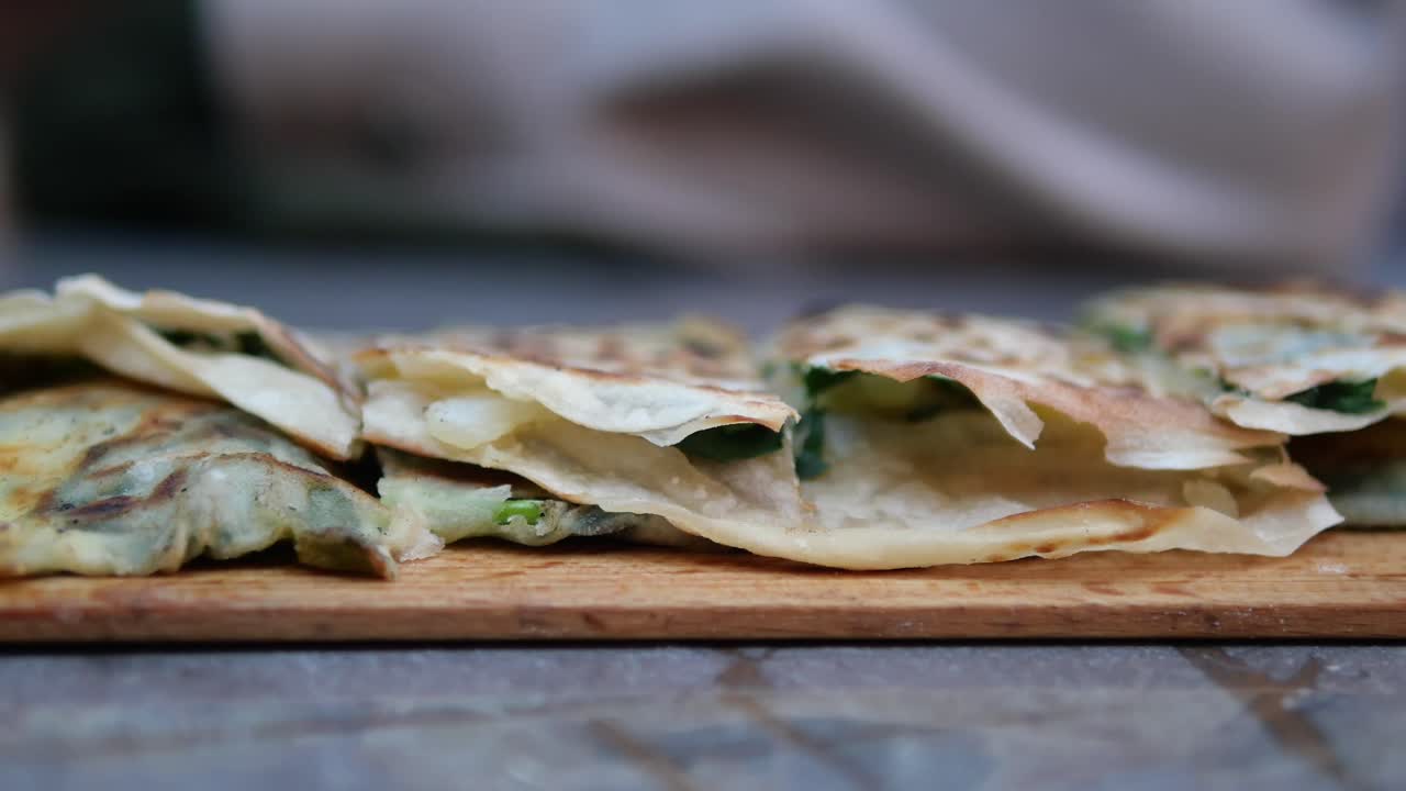 Close-up of scallion pancakes on a wooden board