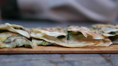 close-up of scallion pancakes on a wooden board