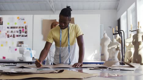 Mixed race man working in fashion office