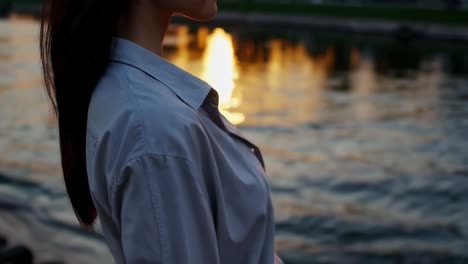 woman in profile at sunset by the river