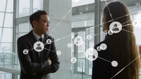 network of profile icons over diverse businessman and businesswoman talking to each other at office