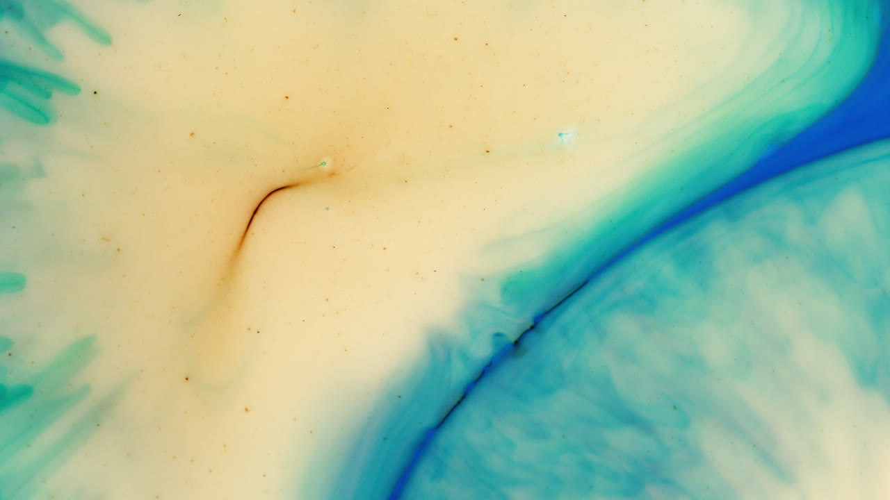 Schizzo di inchiostro scuro opaco si diffonde dal verde al giallo in un liquido trasparente con un cerchio blu