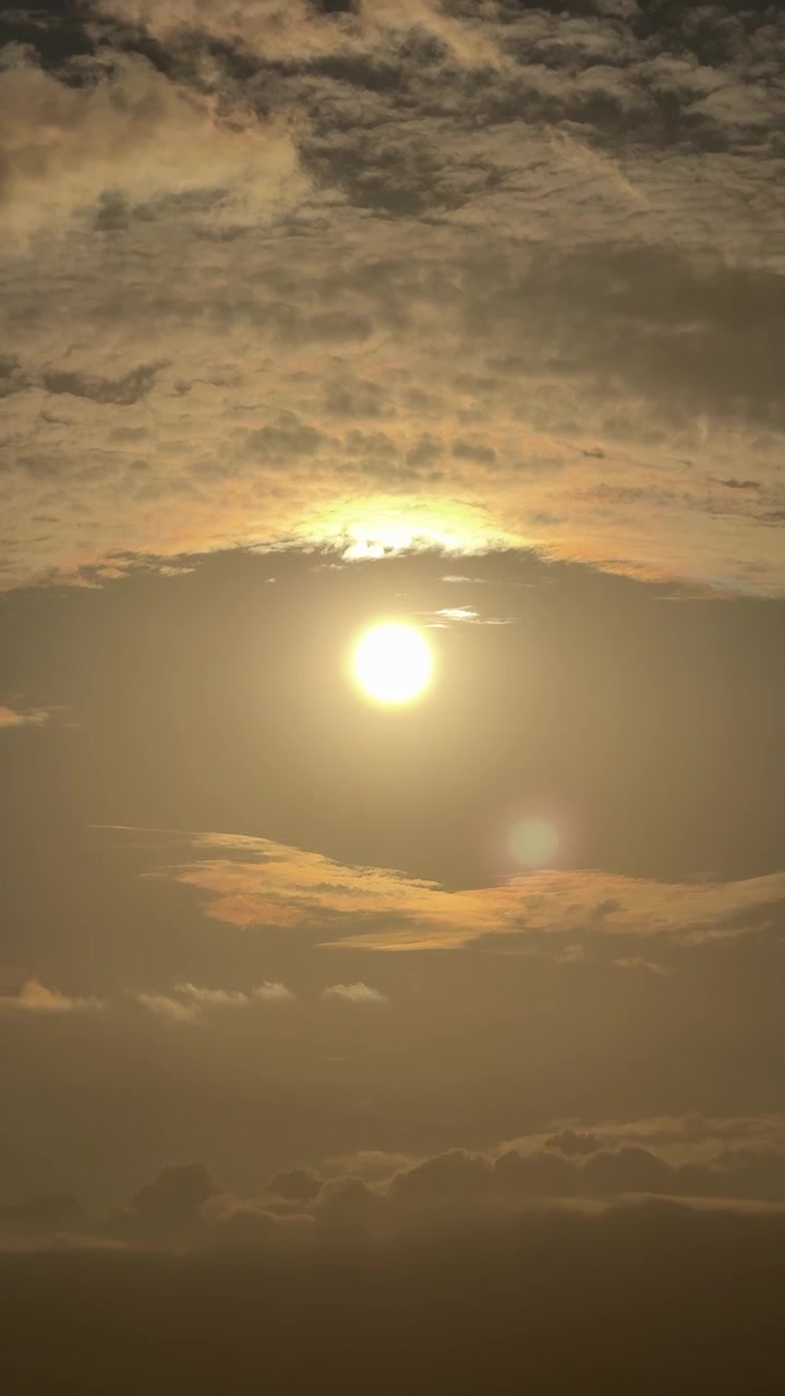 Golden Sun Shining Through Clouds at Sunset or Sunrise