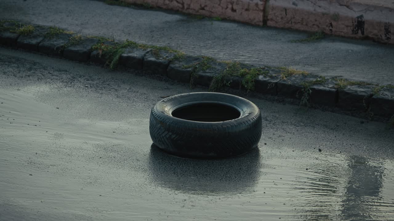 Single tire sits stranded on a rain soaked road during the ongoing Budapest flood crisis