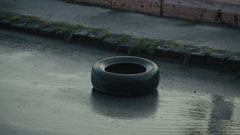 single tire sits stranded on a rain soaked road during the ongoing budapest flood crisis