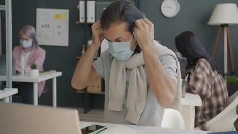 people wearing masks in an office setting during a pandemic
