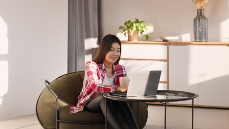 woman working on laptop in cozy home office