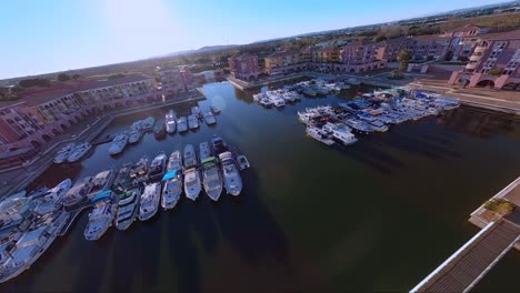 Fpv-diving-shot-revealing-a-full-port-Ariane-with-luxury-yachts-docked-in-Lattes,-France