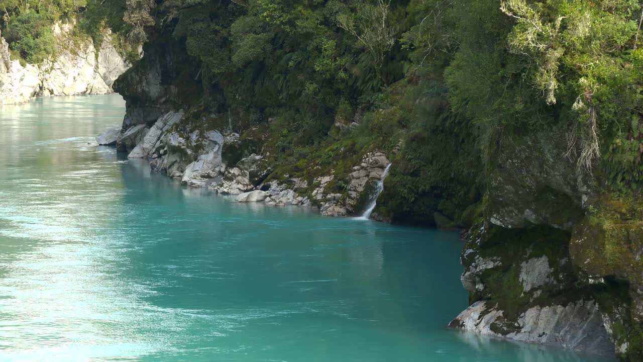 Turquoise Water Of Hokitika Gorge Along The Green Forest With Waterfalls In West Coast, New Zealand. - wide shot