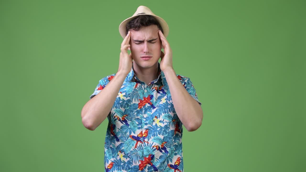 Young handsome tourist man having headache