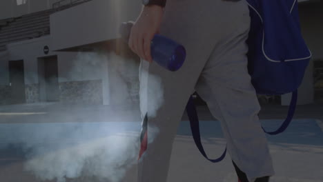 holding blue bottle, person spraying mist in outdoor sports facility animation