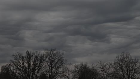 a dramatic display of undulatus asperatus clouds forms wavy, textured layers across the sky, creating a surreal and turbulent atmosphere. includes copy space.