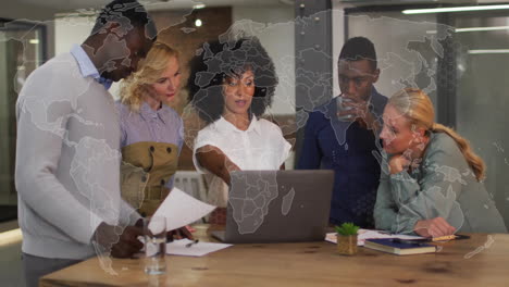 diverse team collaborating over laptop with world map animation overlay