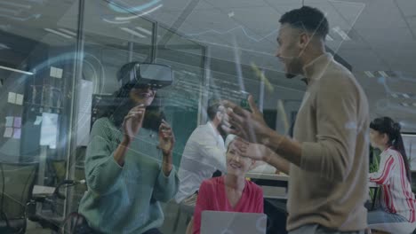 animation of statistical data processing over biracial woman wearing vr headset at office