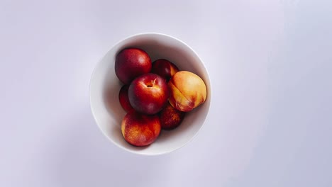 peaches in a white bowl