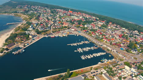 panoramic view of drone flying above the city of jastarnia with marina and yachts and baltic sea in the background