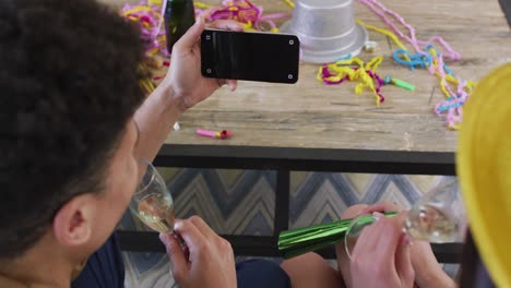 happy biracial couple making celebration smartphone video call with copy space on screen