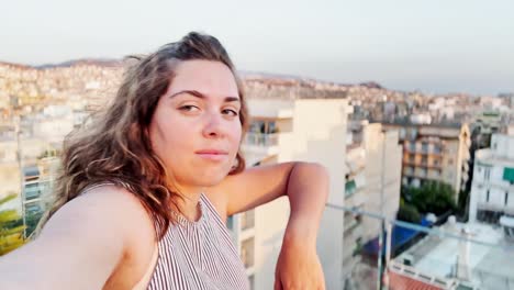 woman vlogger leaning on railing admiring athens view