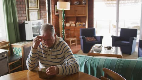 senior man sitting at the table at home