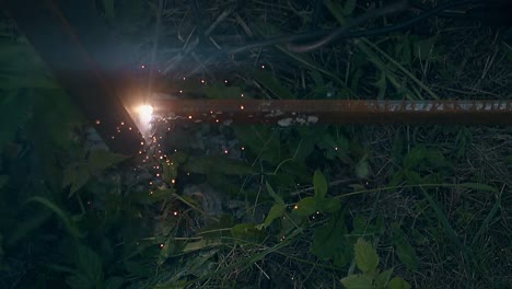 slow-motion-welding-of-fence-bottom-among-green-leaves