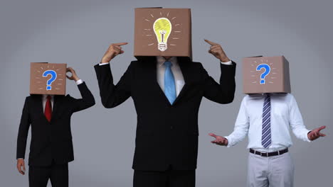 Team-of-businessman-hiding-head-with-box-and-gesturing