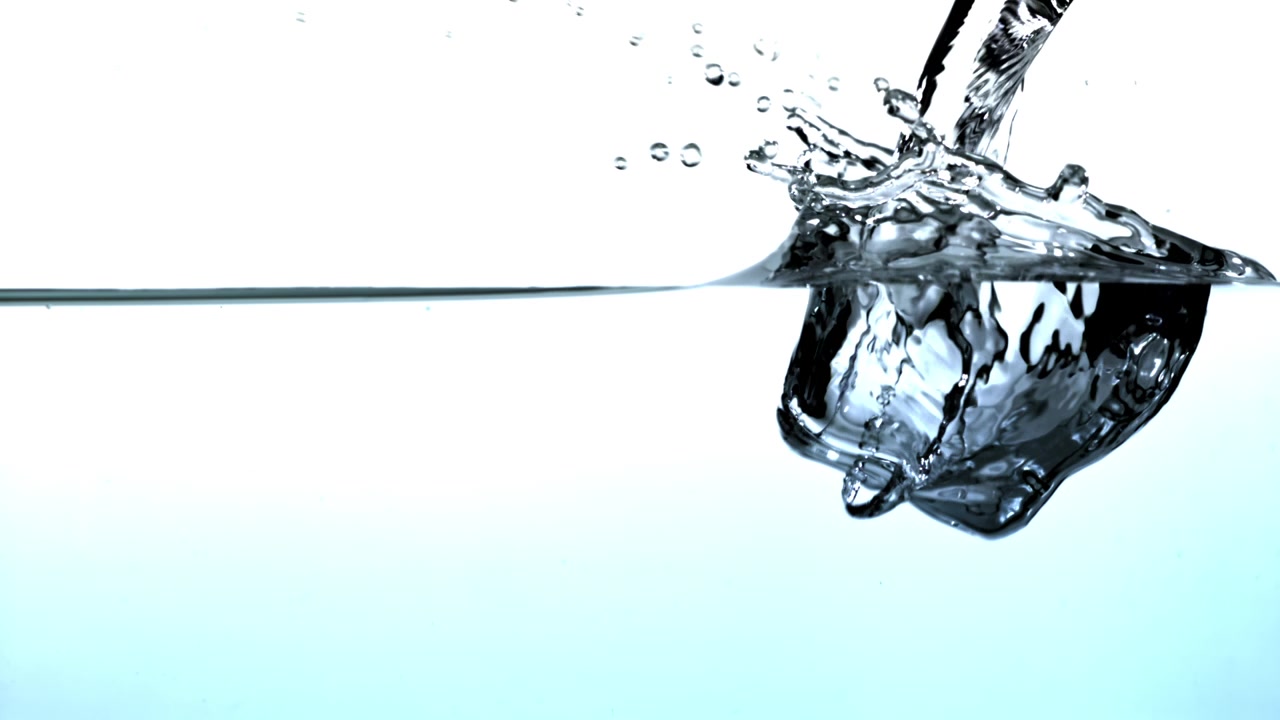 Clear Water Pouring and Splashing with Bubbles in Slow Motion