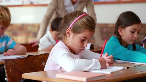 Schoolchildren-colouring-in-books-in-classroom