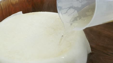 cook pouring boiled rice seasoning