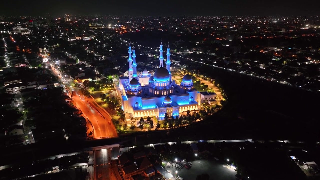 Cityscape of Solo, Indonesia at night. Birds eye view of Great Mosque, illuminated blue light.