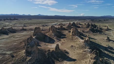 high aerial view pulling away slowly from the trona pinnacles rock formations on a sunny morning