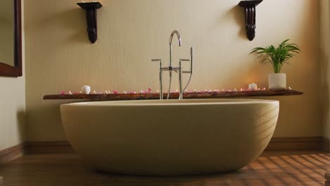 Bathtub-with-candles-and-flower-petals-prepared-for-hot-bath