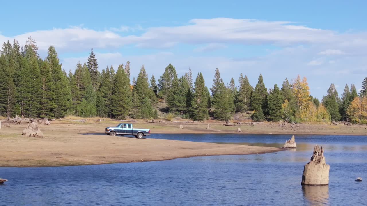 Truck parked by a tranquil lake with trees, Scotts Lake Tahoe, California