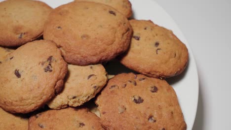 Golden-Brown-Chocolate-Chip-Cookies-on-White-Background,-Pan-Right-to-Copy-Space