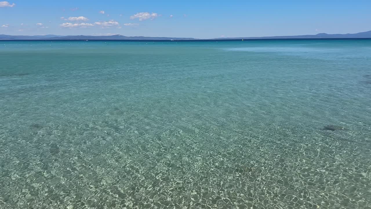 Stunning beach scene in Halkidiki, Greece, with elegant sunbeds facing the crystal-clear turquoise sea. A perfect summer escape in the heart of the Aegean.