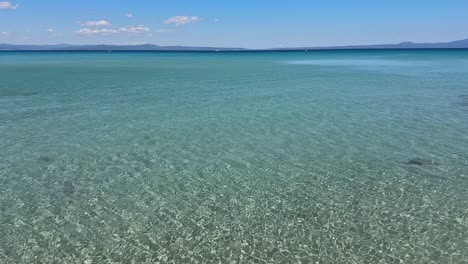 stunning beach scene in halkidiki, greece, with elegant sunbeds facing the crystal-clear turquoise sea. a perfect summer escape in the heart of the aegean.