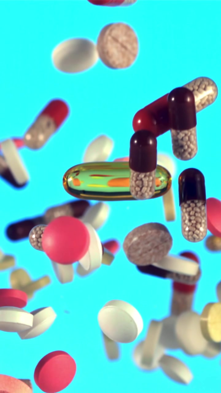 Assorted Medical Pills and Capsules Falling Against a Bright Blue Background
