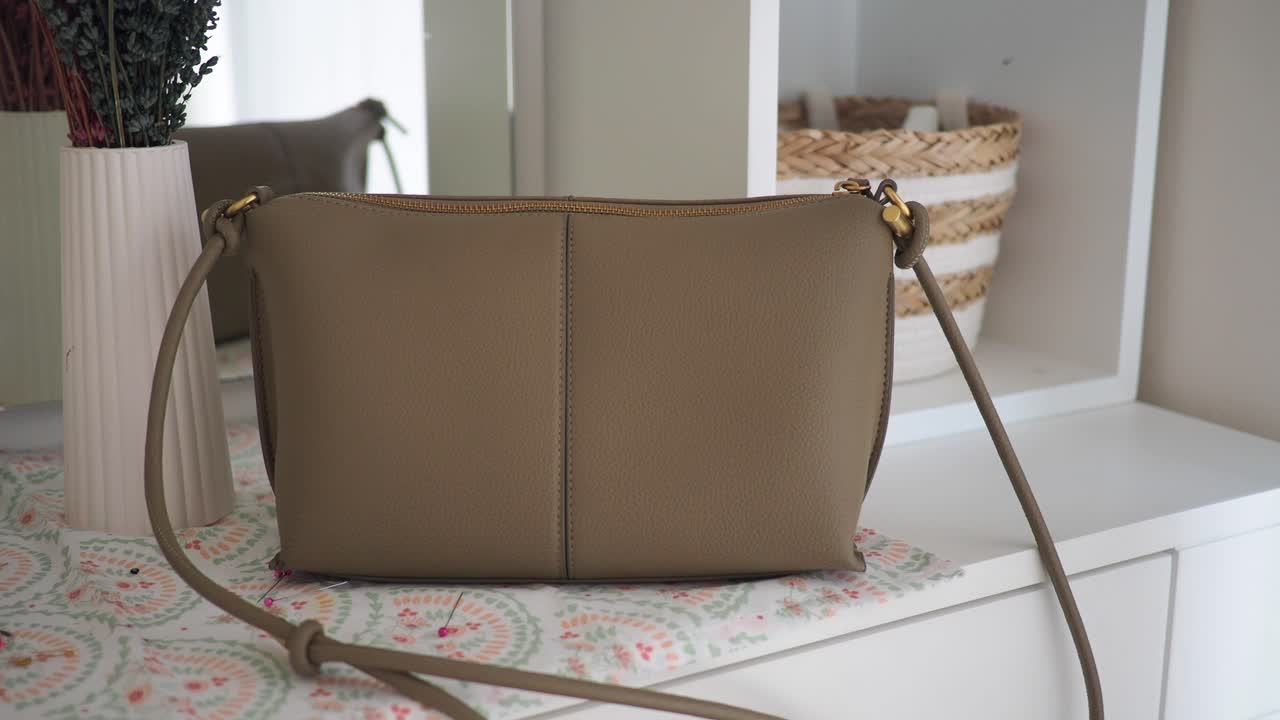 Beige Shoulder Bag on a Dresser