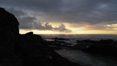 the stunning sunset view from the rocky shores of the fiji islands - wide shot