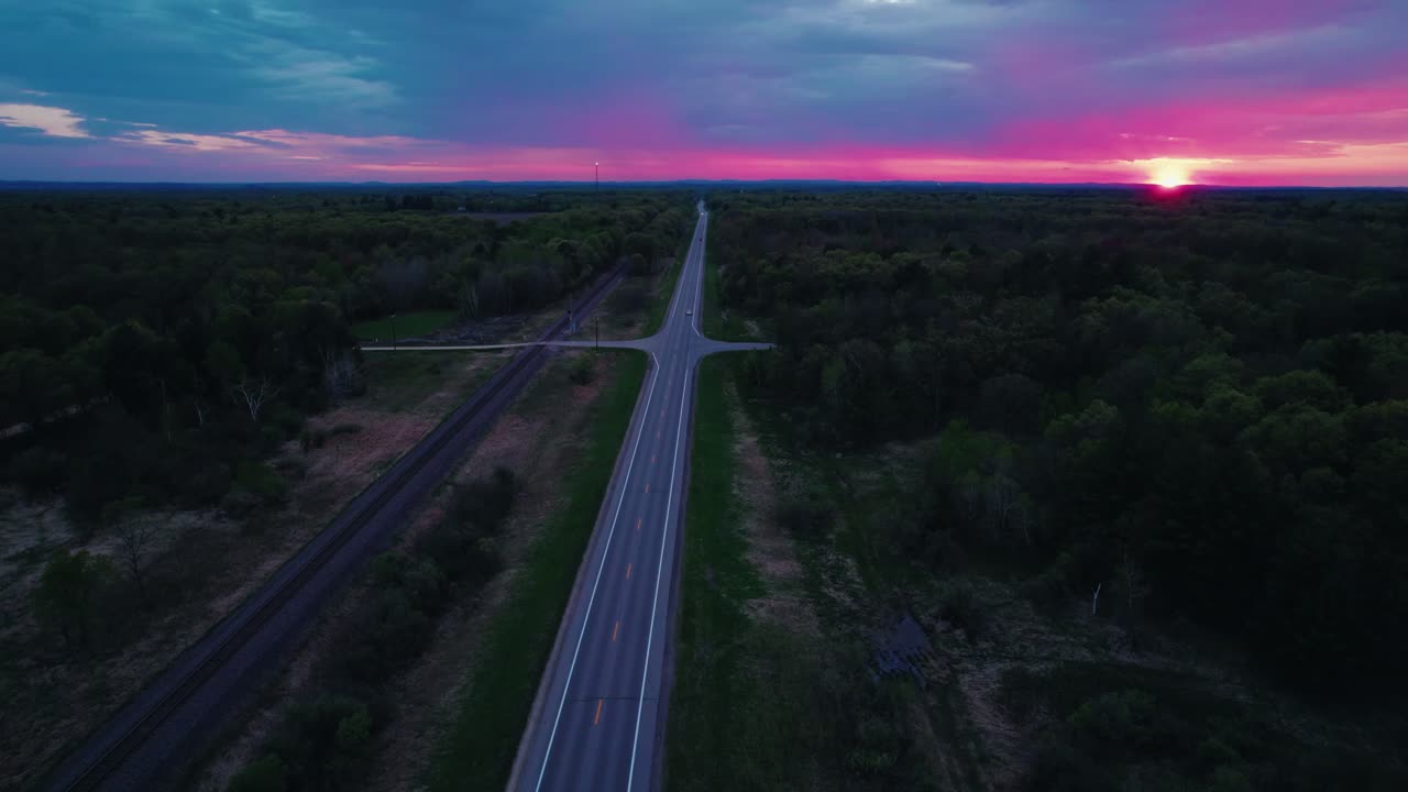 Sunset Drone Aerial of Forest-Lined Highway in Wisconsin