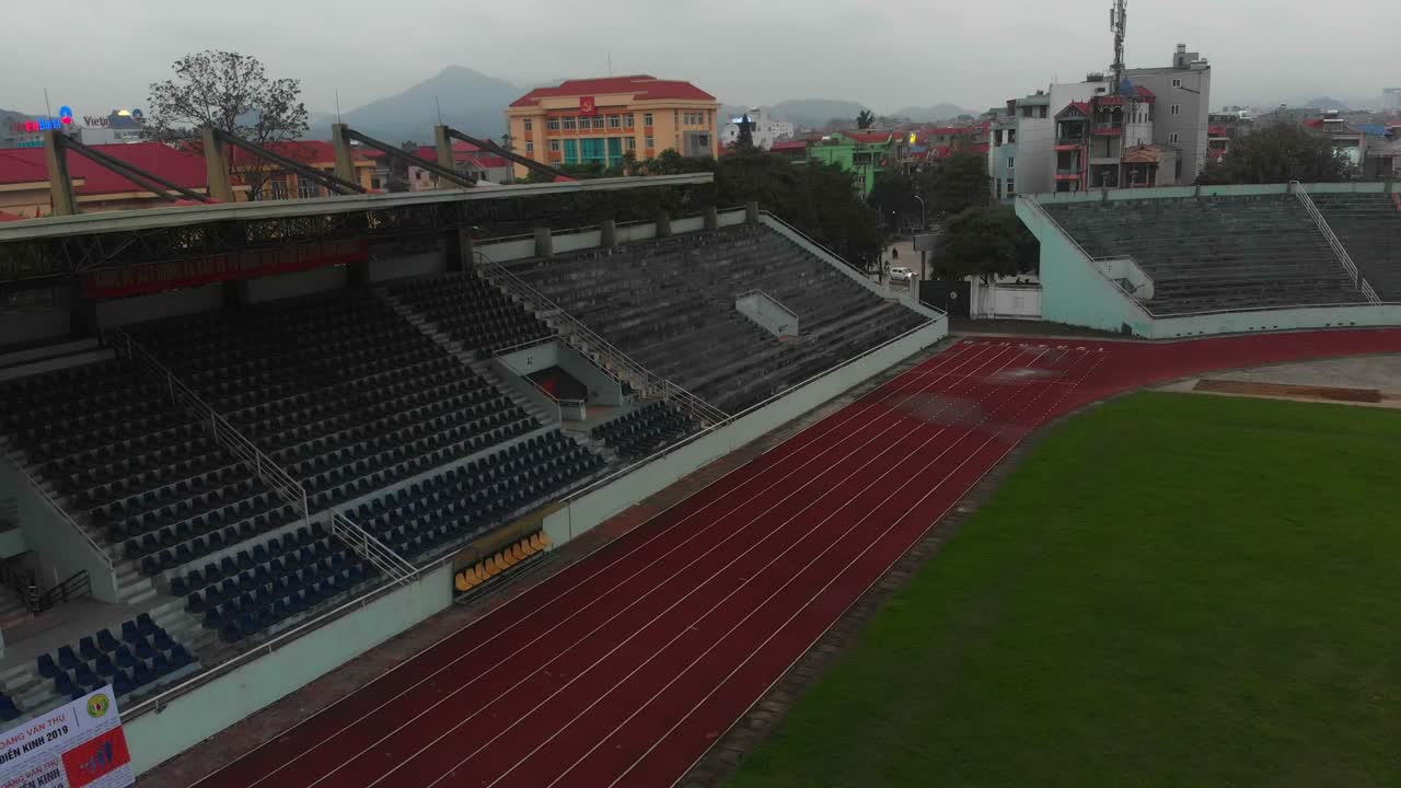 Aerial view of Lang Son city stadium with walkers on soccer fields showing active urban community space