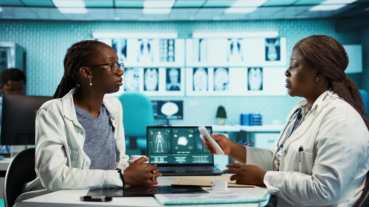 Black medic measuring the temperature during routine checkup at the clinic