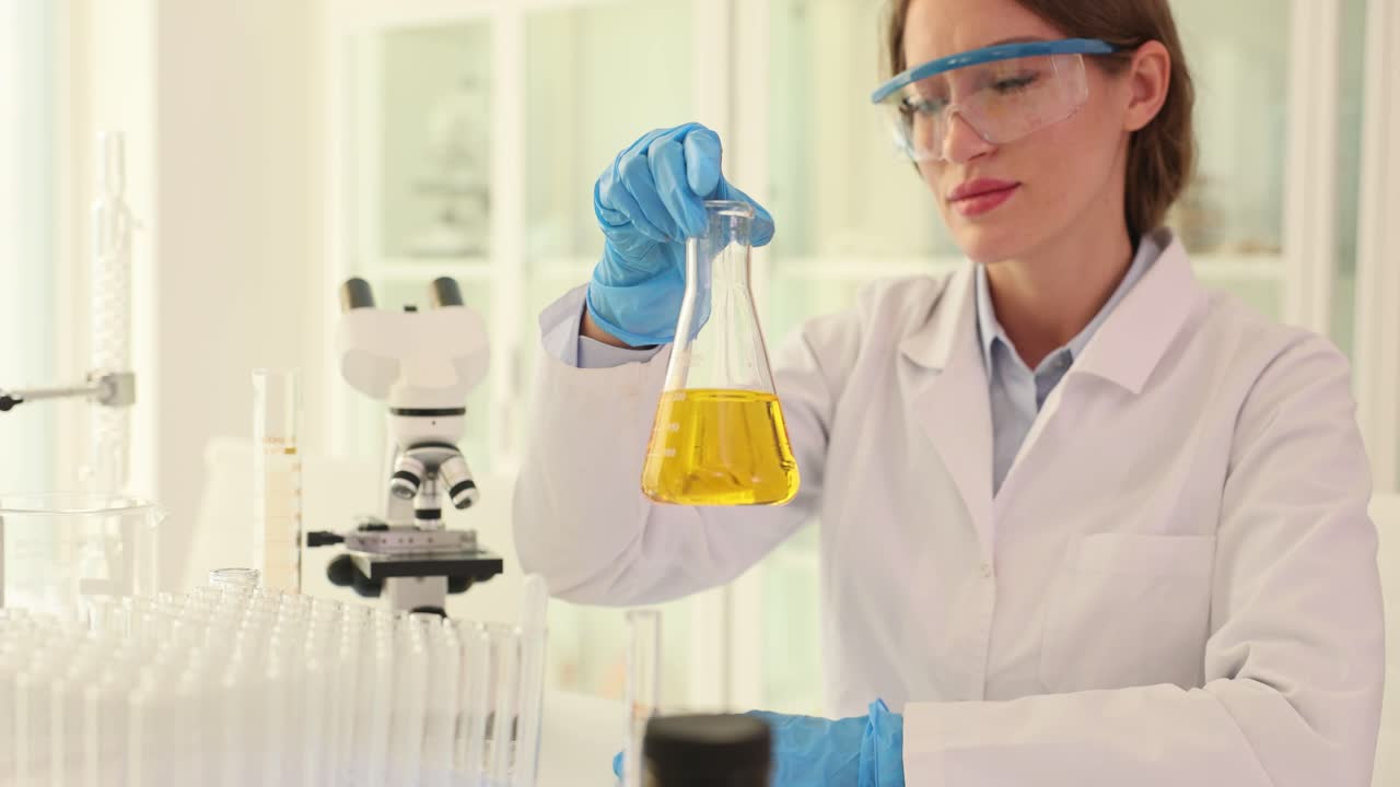 Scientist in laboratory with flask