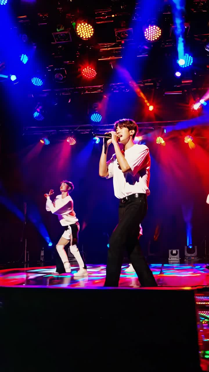 Energetic k-pop band dancing and singing on a brightly lit stage during a concert, creating a vibrant and captivating performance for the audience