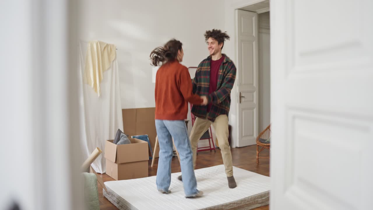 Couple Dancing on Mattress in New Apartment