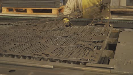 Unrecognizable person working with metal parts steel industrial production